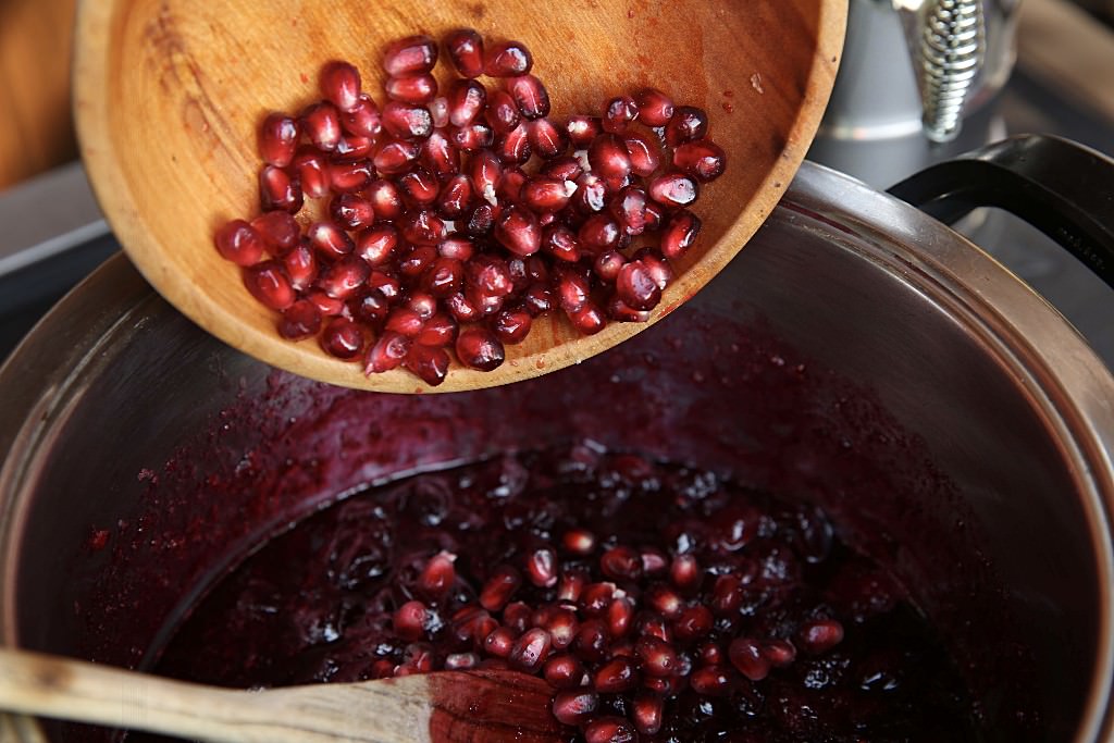 Pomegranate put into reduced cranberry sauce cooked over fontana wood-burning oven