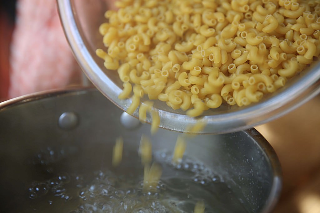 Pasta in boiling water for mac and cheese baked in the Fontana wood-burning oven 