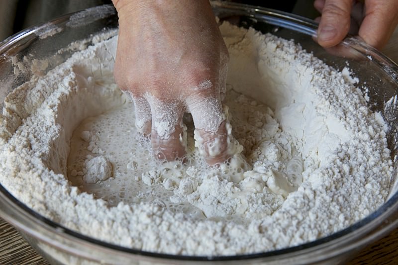 Mix yeast, flour and water together for bread baked in the Fontana wood-fired oven