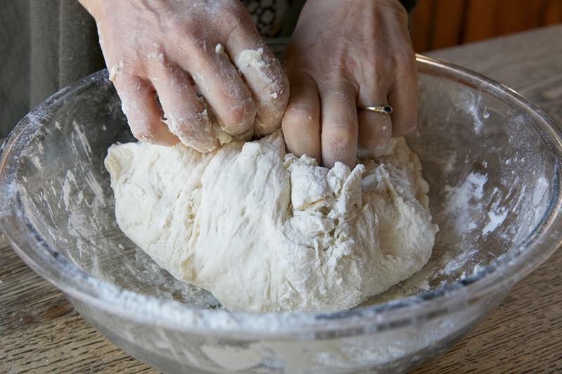 Mix ingredients together for bread baked in the Fontana wood-fired oven