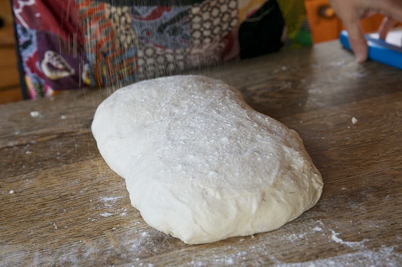 Place risen dough on the table for bread baked in the Fontana wood-burning oven