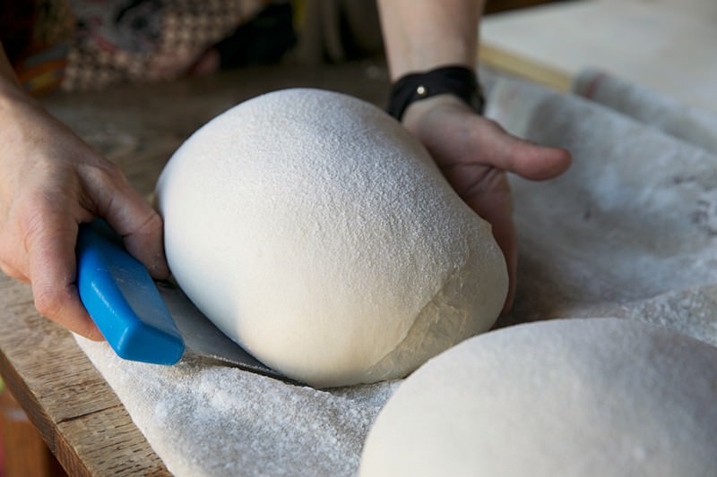 Place risen dough on peal for bread baked in the Fontana wood-fired oven