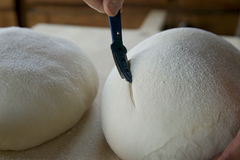 Score dough for bread baked in the Fontana wood-burning oven