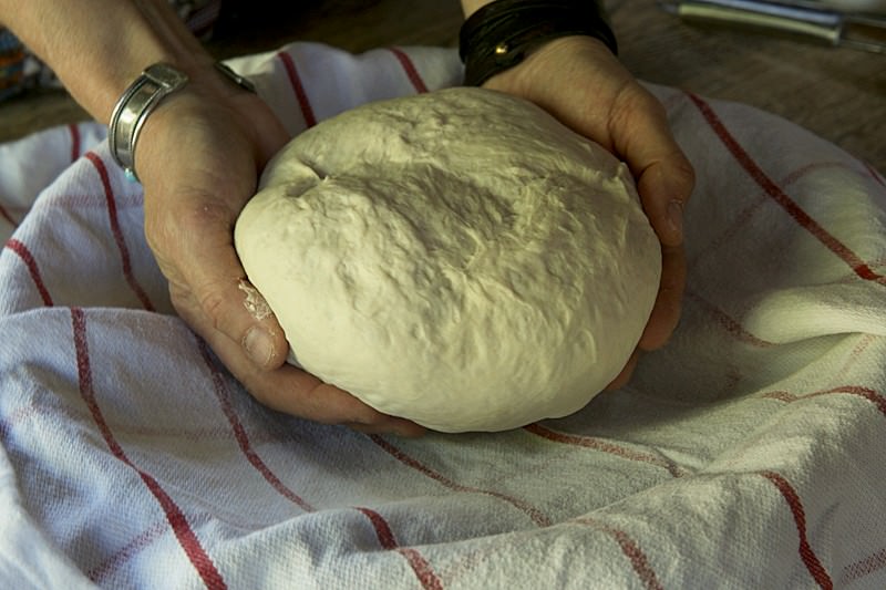 Place bread dough in basket to be baked in the Fontana wood-burning oven 