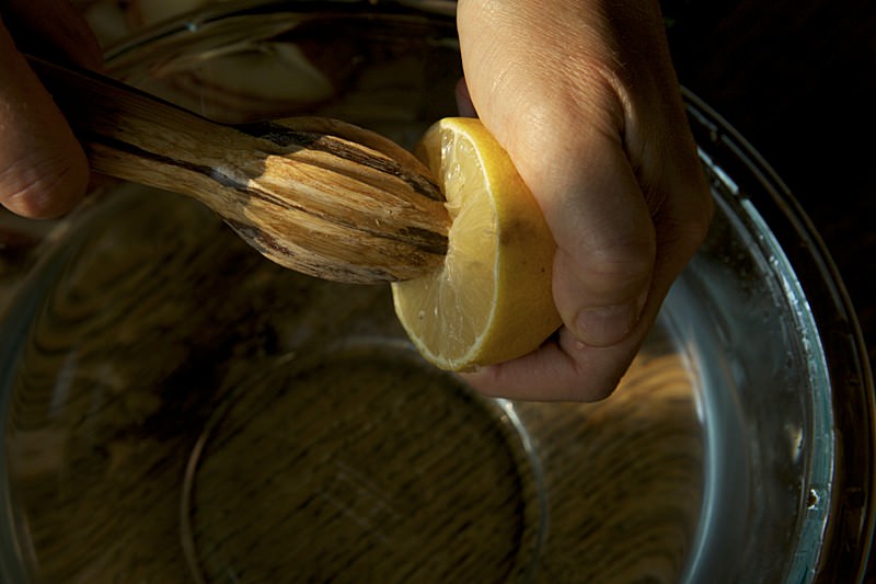 Squeeze the juice of one lemon into a bowl with water