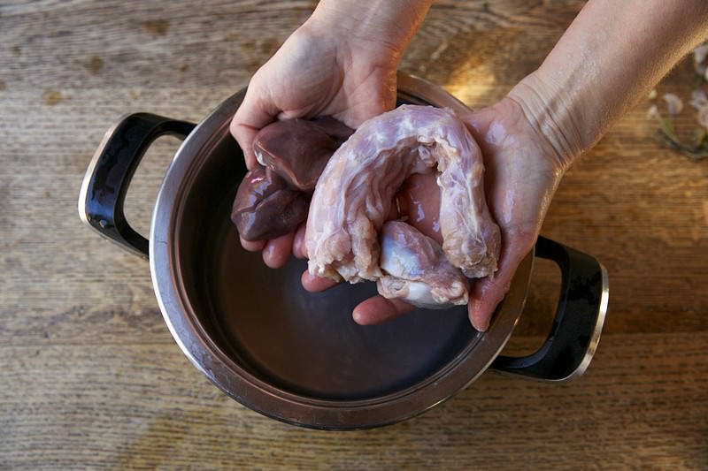 Pouring brine on turkey to be baked in Fontana wood-fired oven 