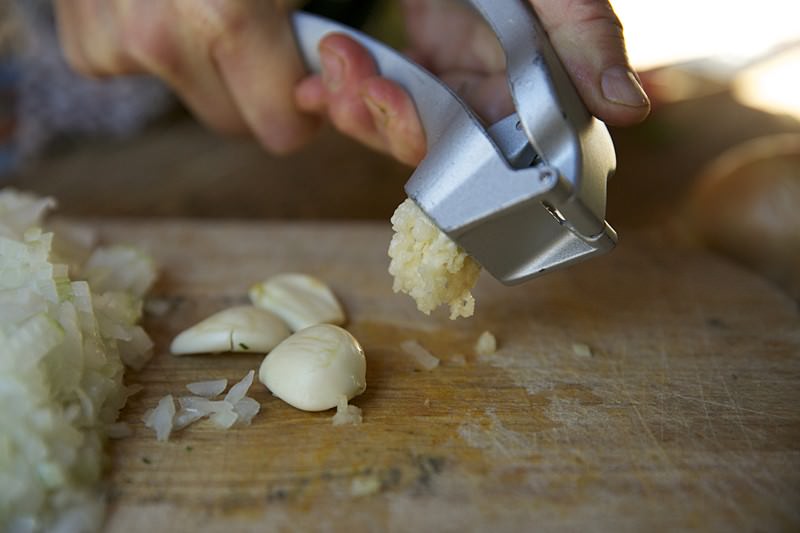 Garlic crushed for turkey to be baked in Fontana wood-burning oven 