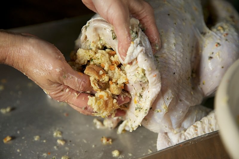 Stuffing the  turkey to be baked in Fontana wood-fired oven