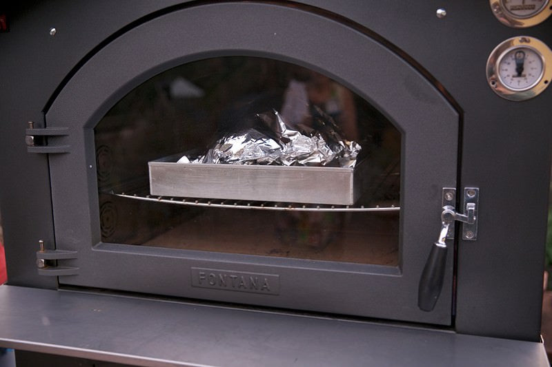 Place foil on turkey in the Fontana wood-burning oven 
