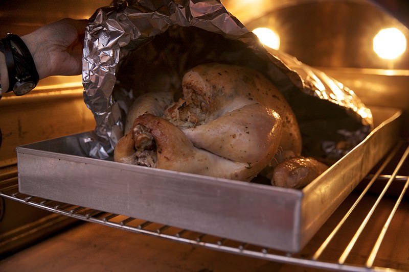 Placing turkey in the Fontana brick oven 