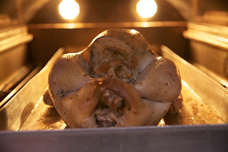 Placing turkey in the Fontana brick oven 