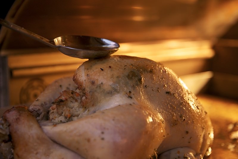 Basing the turkey in the Fontana wood-fired oven 