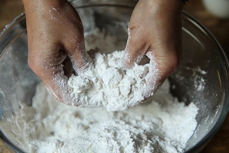 With a pastry cutter or with your fingers cut the chilled butter into the flour.