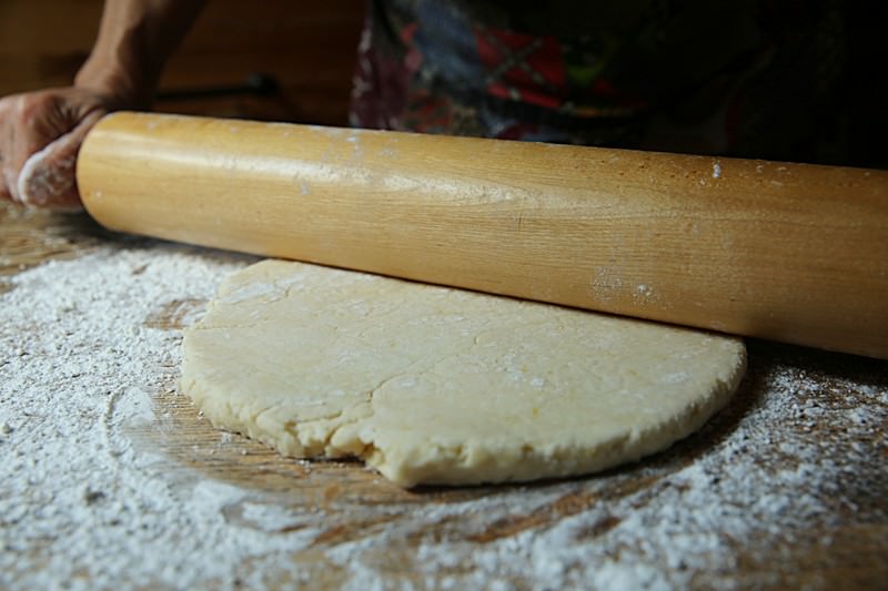 Flour the work surface and the dough and gently roll it out.