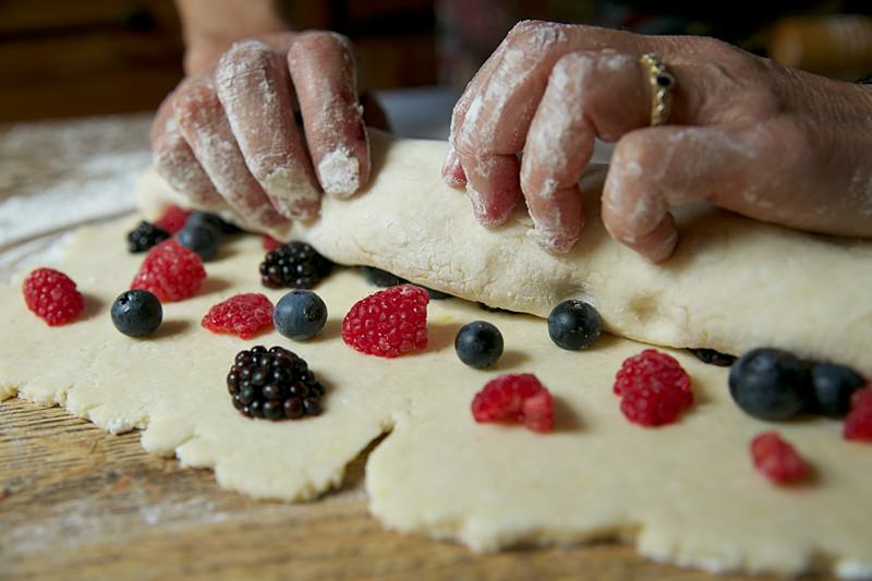 Finish rolling the entire dough making sure the fruit is folded inside the roll.