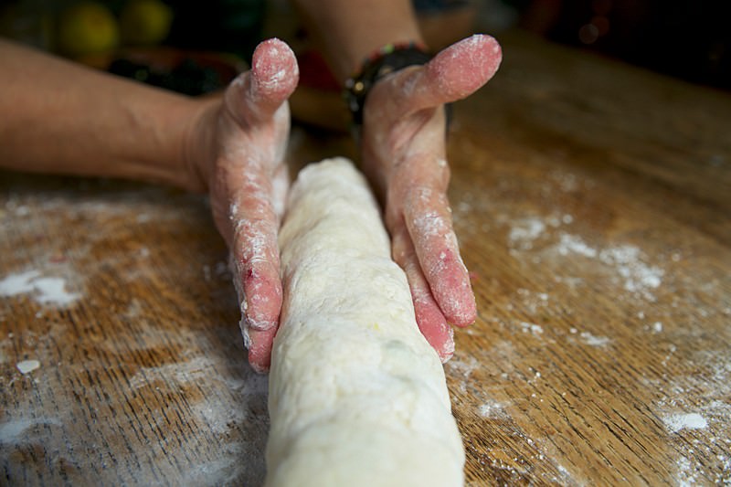 You can either shape the roll with your hands or with the help of a dough scraper.
