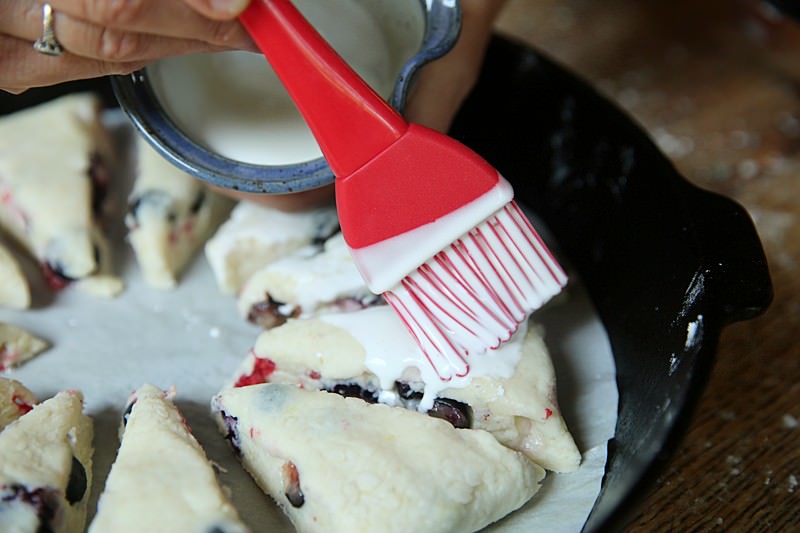 Spread the cream over the scones with a brush of your choosing.