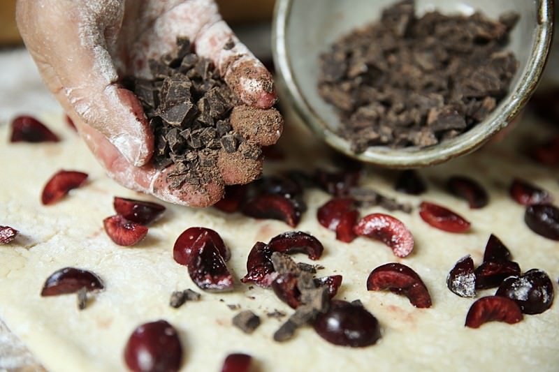 For the final filling, sprinkle the chocolate over and around the cherries.