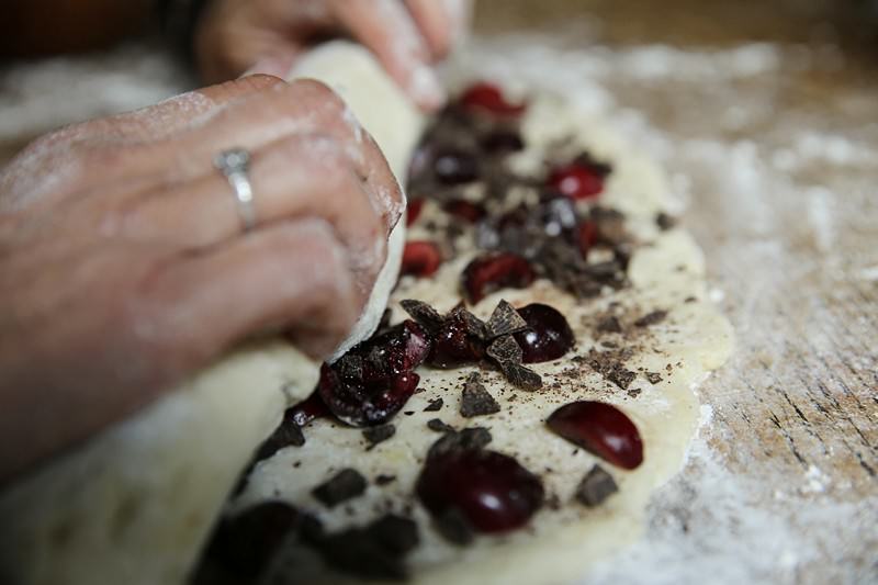 You can use a spatula or dough cutter to carefully lift the dough from the work surface if it is sticking.