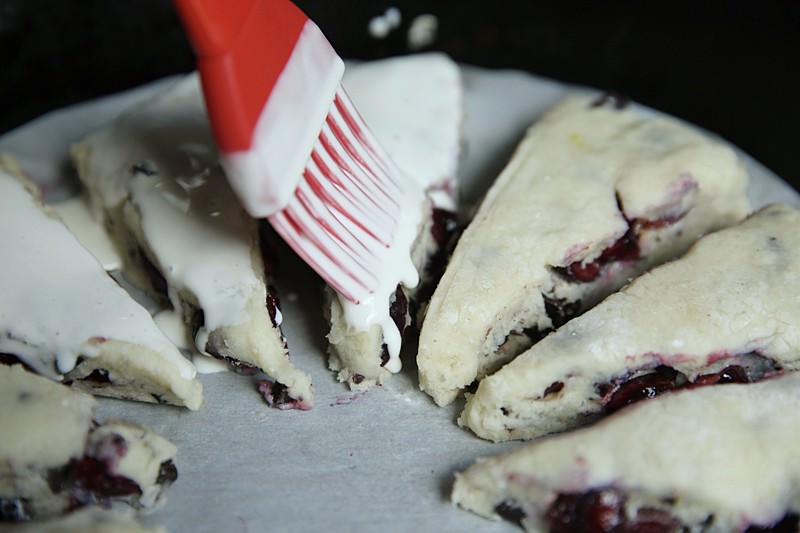 Spread the cream over the scones with a brush.