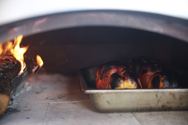 As soon as the peppers reach a charred appearance, they are ready to be rotated.