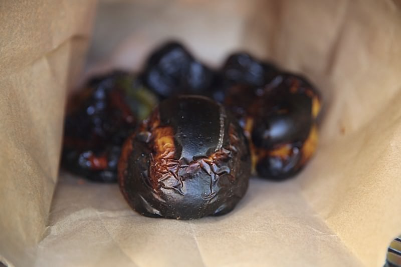 Quickly place the peppers into a paper bag and close it by rolling the opening on itself.