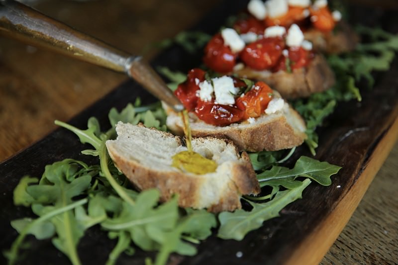 serving cherry tomato crostini made in the Fontana pizza oven