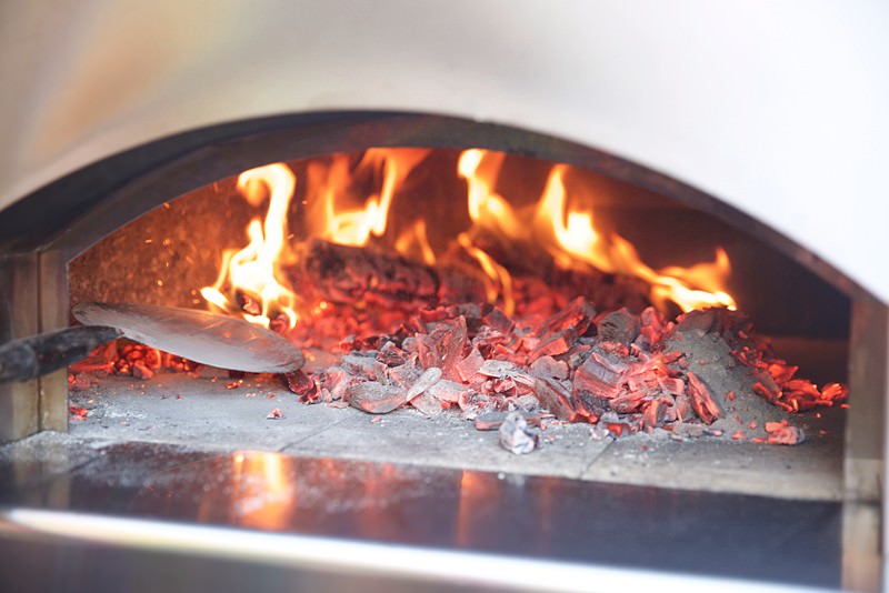 Spread the coals across the floor of the oven