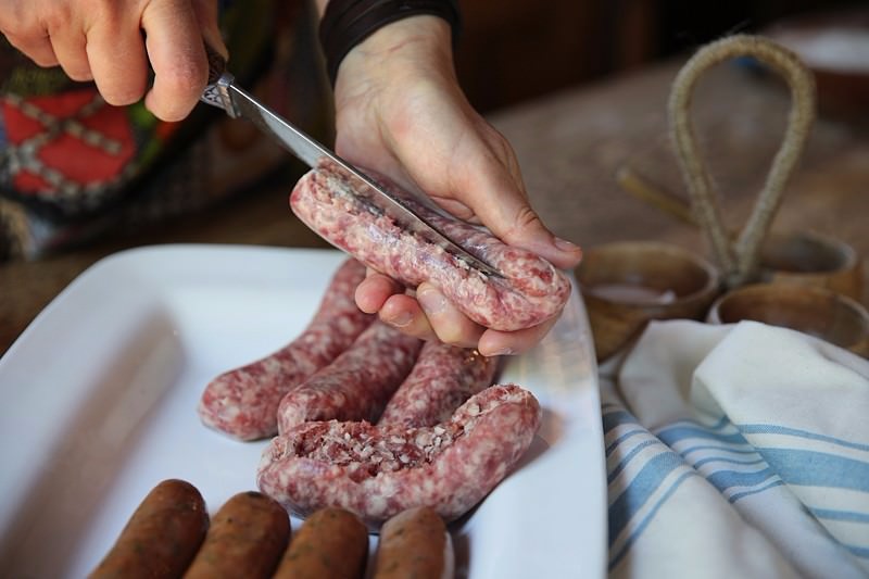 Slice the sausage lengthwise being careful not to cut all the way through