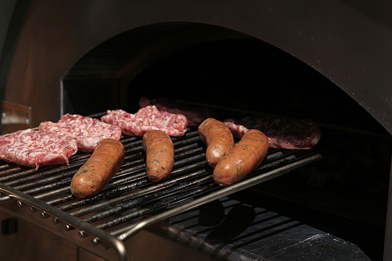 Place the sausage and the bratwurst on the hot grill