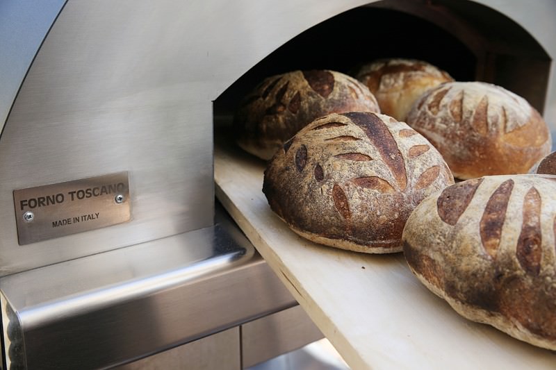 Bread being pulled out of the Fontana wood-fired oven