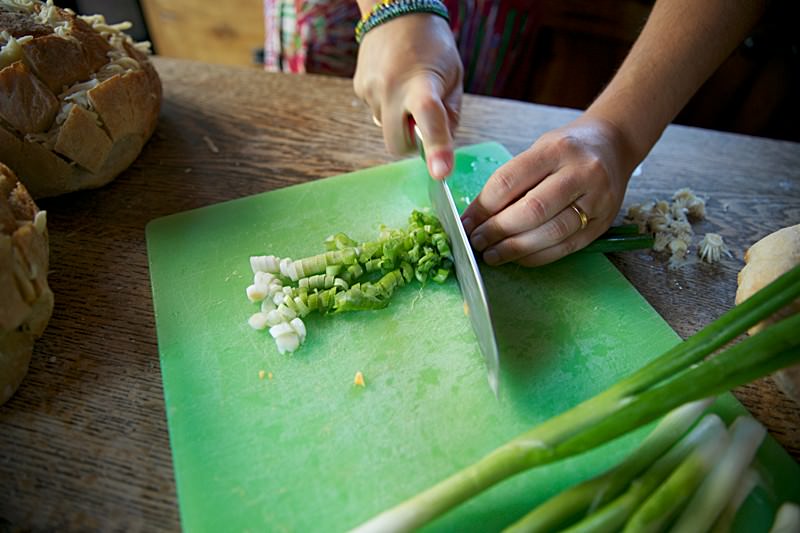 With the help of a sharp knife dice a few green onions