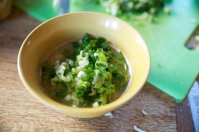 "Melt a stick of butter in a bowl and add the green onions