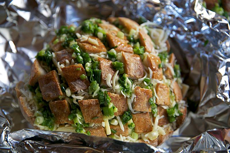 wrap the Stuffed Blooming Cheesy Bread in aluminium foil.  Cover each loaf completely