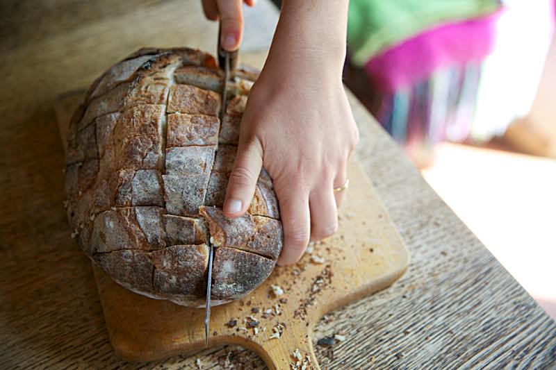 With a serrated knife make deep cuts into the bread until the blade reaches almost the bottom of the loaf