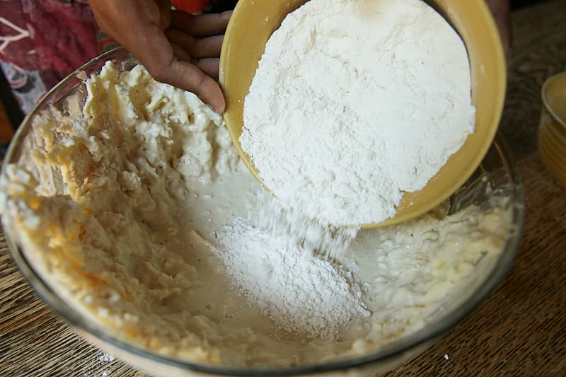 Gently stir in the 1 1/2 -2 cups flour, half cup at a time, until a wet dough forms.