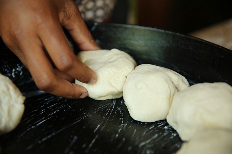 Place each ball side by side in a buttered cast-iron skillet