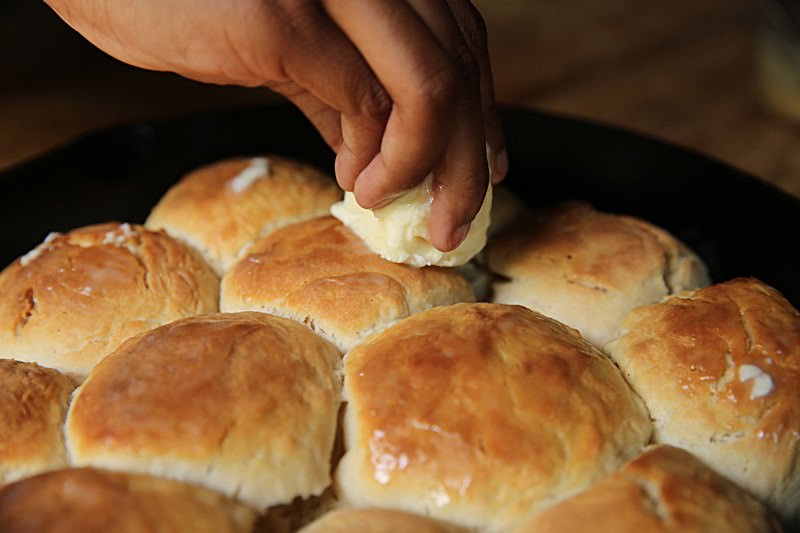 Spread some additional butter over the top of the biscuits