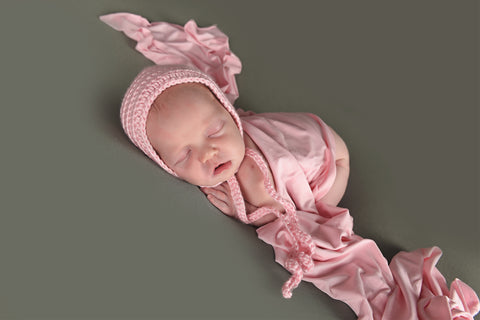 Pale pink newborn baby bonnet by Two Seaside Babes