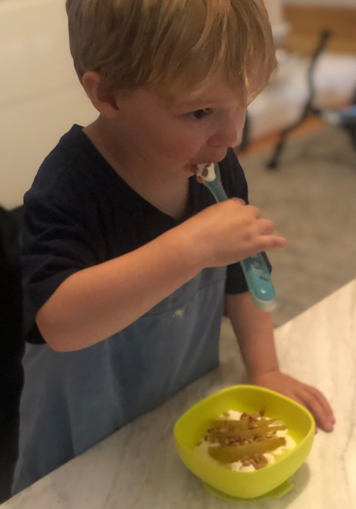 Toddler eating Steamed Pear Breakfast Yoghurt