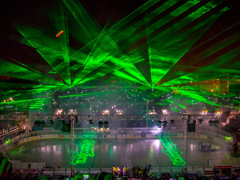 Kvant laser show with laser text displayed at hockey game