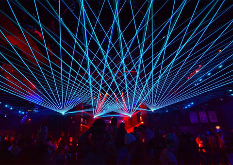 blue laser beams projecting over crowd