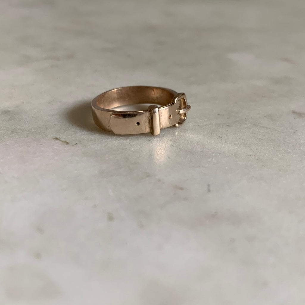 gold belt buckle ring meaning