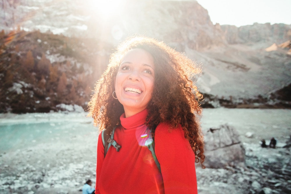 woman hiking in bright sunlight