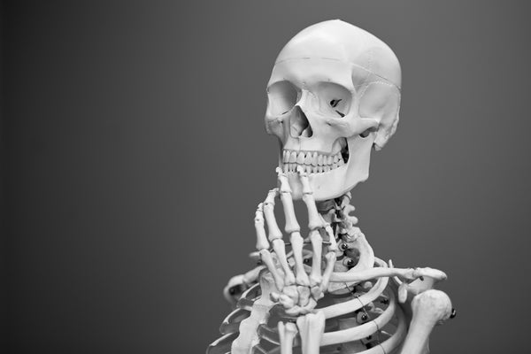 skeleton with fingers on chin