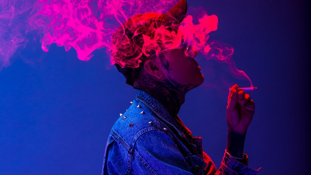 man smoking colorful pink smoke