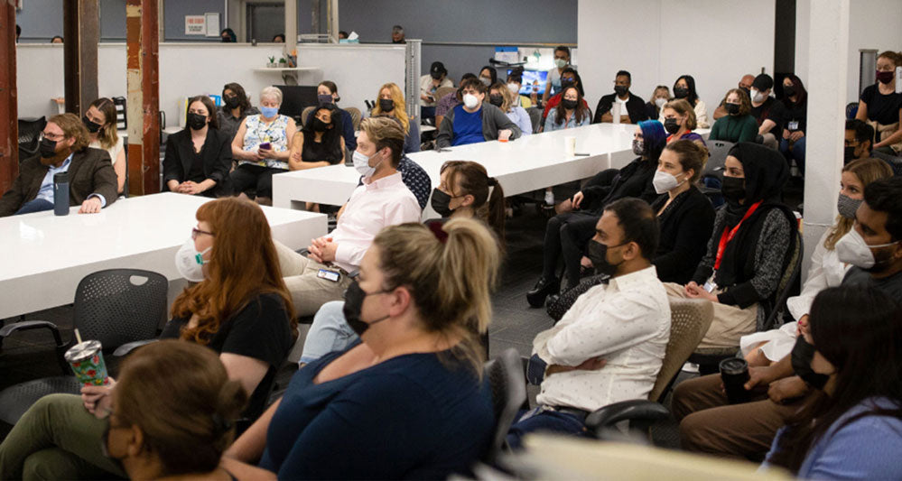 Mondetta staff seated and listening to Brian McLeod and Bram Strain