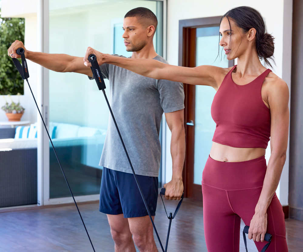 MPG male and female models doing a resistance workout in their home