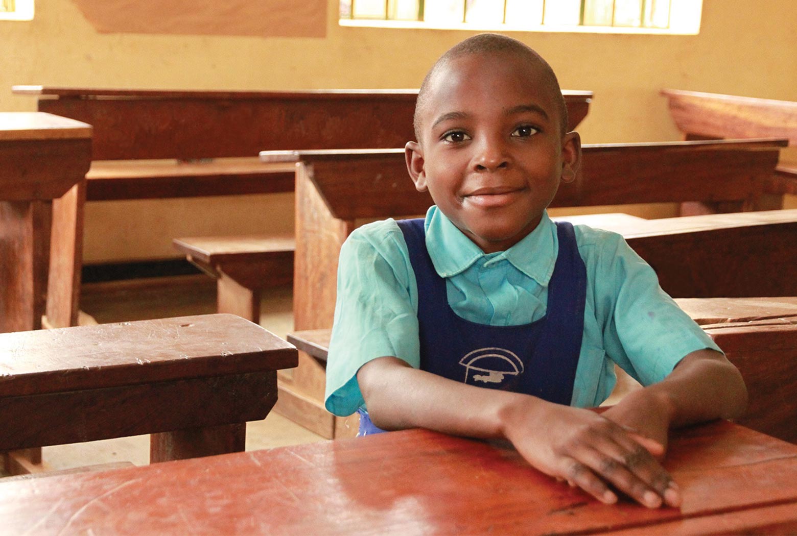 Young boy in the classroom at Kamwoyka Primary School in Kampala, Uganda