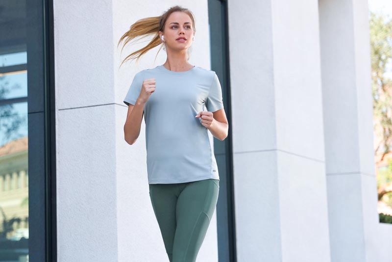 Mondetta female model running in Women's Active Tee in Abyss Green